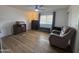 Bedroom with ceiling fan, wood dresser, and comfy recliner at 4624 E Emerald Ave, Mesa, AZ 85206