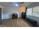 Bedroom with ceiling fan, wood dresser, and comfy recliner at 4624 E Emerald Ave, Mesa, AZ 85206