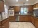 View of kitchen with wood cabinets, granite countertops, and stainless steel appliances at 4624 E Emerald Ave, Mesa, AZ 85206