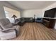 Bright living room with wood-look floors and a sectional sofa at 4624 E Emerald Ave, Mesa, AZ 85206