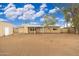 Large backyard with gravel, covered patio, and storage shed at 4809 W Sandra Ter, Glendale, AZ 85306