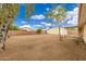 Large backyard with gravel, covered patio, and storage shed at 4809 W Sandra Ter, Glendale, AZ 85306