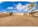 Large backyard with gravel, covered patio, and storage shed at 4809 W Sandra Ter, Glendale, AZ 85306