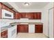 Galley style kitchen with wood cabinets and appliances at 4809 W Sandra Ter, Glendale, AZ 85306