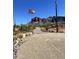 Gravel driveway leading to the home with mountain backdrop at 5063 E Reavis St, Apache Junction, AZ 85119