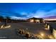 Night view of home exterior with landscape lighting at 5063 E Reavis St, Apache Junction, AZ 85119