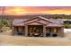 House exterior showcasing a patio, fire pit, and sunset view at 5063 E Reavis St, Apache Junction, AZ 85119