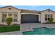 Home exterior featuring a retractable garage screen and landscaping at 5252 N 206Th Dr, Buckeye, AZ 85396