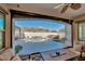 Sunroom with view of the backyard pool and mountains at 5252 N 206Th Dr, Buckeye, AZ 85396