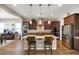 Modern kitchen with granite island, stainless steel appliances, and dark cabinets at 5252 N 206Th Dr, Buckeye, AZ 85396