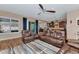 Spacious living room with leather furniture and a view into the kitchen at 5252 N 206Th Dr, Buckeye, AZ 85396