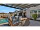 Outdoor kitchen with built-in grill, under-counter refrigerator, and pergola at 5252 N 206Th Dr, Buckeye, AZ 85396