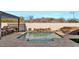 Inviting pool with a stone water feature and spacious patio at 5252 N 206Th Dr, Buckeye, AZ 85396