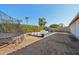 Inviting backyard oasis featuring a refreshing pool, trampoline, and lush landscaping at 5582 W Aster Dr, Glendale, AZ 85304