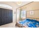 Charming bedroom featuring a four-poster bed, plantation shutters, and a cozy ambiance at 5582 W Aster Dr, Glendale, AZ 85304