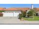 Beautiful home featuring a tile roof, manicured lawn, and a two-car garage at 5582 W Aster Dr, Glendale, AZ 85304