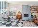 Living room with a fireplace, checkerboard floor, and large window at 5582 W Aster Dr, Glendale, AZ 85304