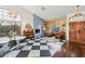 Bright and airy living room with a fireplace and checkerboard floor at 5582 W Aster Dr, Glendale, AZ 85304