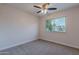 Spacious bedroom with carpeted floors, a ceiling fan, and a window at 600 S Dobson Rd # 166, Mesa, AZ 85202