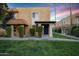 Tan stucco building with a blue front door and landscaped lawn at 601 E Palo Verde Dr # 14A, Phoenix, AZ 85012