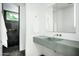 Modern bathroom featuring a sleek floating sink and a walk-in shower with black tile at 6529 E Camino De Los Ranchos St, Scottsdale, AZ 85254