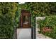 Lush, verdant walkway leads to a private entrance and features the property's signage at 6529 E Camino De Los Ranchos St, Scottsdale, AZ 85254