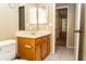 Bathroom with wood vanity, toilet and view into bedroom at 7456 W Greer Ave, Peoria, AZ 85345