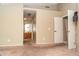 Spacious carpeted bedroom with neutral walls and access to bathroom at 7456 W Greer Ave, Peoria, AZ 85345