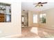 Spacious living room with large windows and ceiling fan at 7456 W Greer Ave, Peoria, AZ 85345