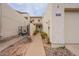 Inviting entryway with a paved pathway, landscaping, and access to the garage at 7764 N 19Th Dr, Phoenix, AZ 85021