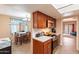 Eat-in kitchen with wood cabinetry and a view into the living room at 7764 N 19Th Dr, Phoenix, AZ 85021