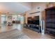 Open living room with a view into the dining area and a large TV at 7764 N 19Th Dr, Phoenix, AZ 85021