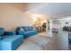 Bright living room with a blue sofa, a rug, and a view of the dining area at 7764 N 19Th Dr, Phoenix, AZ 85021