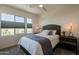 Serene bedroom with comfortable bed, nightstand and large window with blinds at 813 E Verde Blvd, Queen Creek, AZ 85140