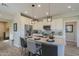 Modern kitchen with white cabinets, stainless steel appliances, and an island at 813 E Verde Blvd, Queen Creek, AZ 85140