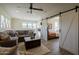 Open living space with sectional sofa, barn doors, and access to a bedroom at 813 E Verde Blvd, Queen Creek, AZ 85140