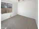 Well-lit bedroom with carpet flooring and a window at 8148 W Atlantis Way, Phoenix, AZ 85043