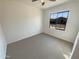 Bright bedroom with carpet flooring and large window at 8148 W Atlantis Way, Phoenix, AZ 85043