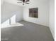 Bright bedroom with carpeted floor, ceiling fan, and large window at 8148 W Atlantis Way, Phoenix, AZ 85043