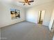 Bedroom with ceiling fan, window, and access to bathroom at 8148 W Atlantis Way, Phoenix, AZ 85043