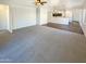 Open concept living room with carpet and views to kitchen at 8148 W Atlantis Way, Phoenix, AZ 85043