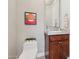 Modern bathroom with a toilet and wood vanity at 8534 E Angel Spirit Dr, Scottsdale, AZ 85255