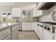 Well-equipped kitchen with white cabinets, granite counters, and a view to the backyard at 8534 E Angel Spirit Dr, Scottsdale, AZ 85255