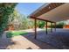 Landscaped backyard with covered patio, fire pit, and artificial turf at 8614 E Valley View Rd, Scottsdale, AZ 85250