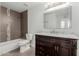 Bathroom with dark vanity, marble countertop, and mosaic tile shower surround at 8614 E Valley View Rd, Scottsdale, AZ 85250