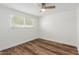 Simple bedroom with wood-look floors and window with blinds at 8614 E Valley View Rd, Scottsdale, AZ 85250