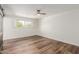 Bright bedroom with wood-look floors and barn door at 8614 E Valley View Rd, Scottsdale, AZ 85250