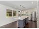 Spacious kitchen featuring white cabinets, an island, and backyard view at 8614 E Valley View Rd, Scottsdale, AZ 85250