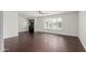 Bright living room with dark wood-look floors and plantation shutters at 8614 E Valley View Rd, Scottsdale, AZ 85250