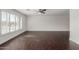 Spacious living room featuring dark wood-look floors and large windows at 8614 E Valley View Rd, Scottsdale, AZ 85250